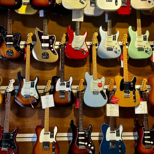 A shop wall covered in electric guitars